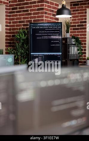 Empty data center office with programming screens during a focused IT task involving diagnostics, digital infrastructure and secure data processing. Stock Photo