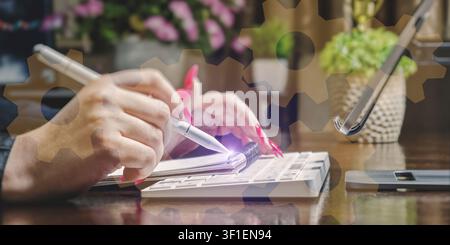 System integration and strategy. Businesswoman working at office desk with holographic cogwheels overlay symbolizing engineering and management. Stock Photo
