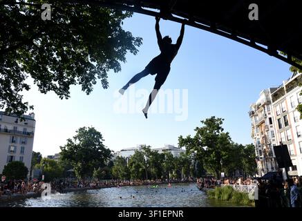 Paris, France. 12th July, 2026. Tourists and parisians cool themselves at Canal Saint-Martin as a Heatwave hits in Paris, 40｡C expected towards temperature records in France on July 12, 2026. Photo by Alain Apaydin/ABACAPRESS.COM Credit: Abaca Press/Ģ����ý Live News Stock Photo