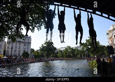 Paris, France. 12th July, 2026. Tourists and parisians cool themselves at Canal Saint-Martin as a Heatwave hits in Paris, 40°C expected towards temperature records in France on July 12, 2026. Photo by Alain Apaydin/ABACAPRESS.COM Credit: Abaca Press/Ģ����ý Live News Stock Photo