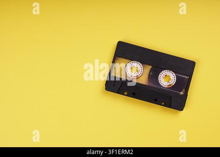 blank music cassette tape on yellow background with copy space Stock Photo