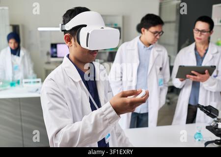 Indian Man Using VR Headset in Science Lab Training Stock Photo