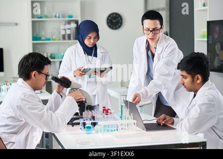 Scientists Collaborating on Medical Research in Laboratory Stock Photo