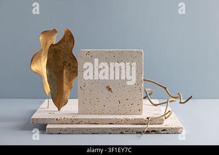 Elegant Minimalist Stone Sculpture with Gold Leaf and Organic Forms on Neutral Background Stock Photo