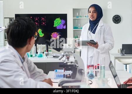 Asian Female Scientist Presenting Research Findings in Laboratory Stock Photo