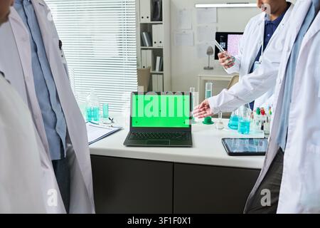 Scientists Presenting Laptop Mockup in Medical Laboratory Stock Photo
