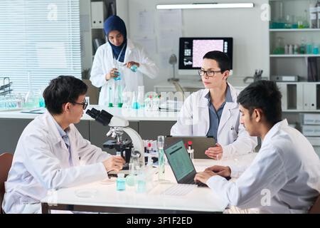 Diverse Medical Researchers Collaborating in Laboratory Meeting Stock Photo