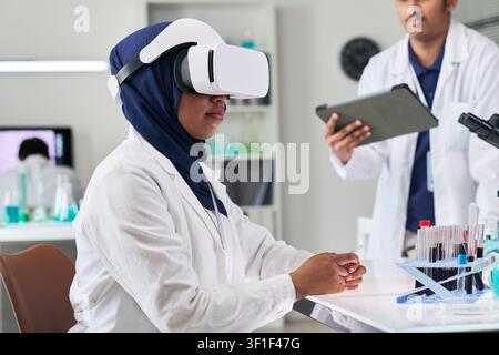 Muslim Woman Using Virtual Reality in Medical Research Stock Photo