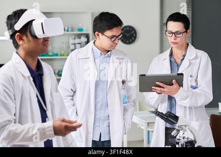 Indian Man Using VR Headset during Medical Research Team Training Stock Photo