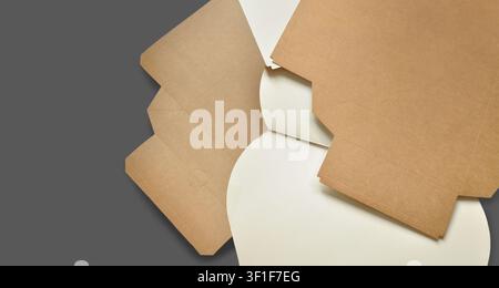 Abstract paper banner, unfolded cardboard boxes, layered. Abstract artistic background. Sustainable packaging concept, packaging template, papers Stock Photo