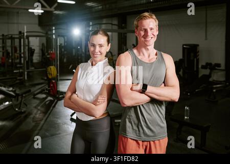 Portrait of Young Fitness Couple Posing in Gym for Wellness Marketing Stock Photo