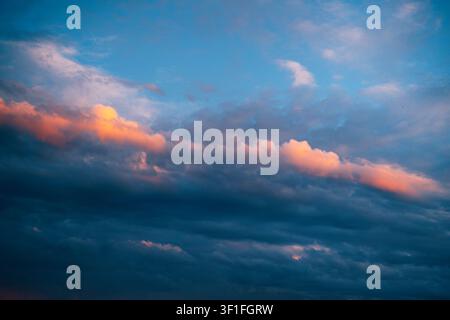 Vibrant sunset clouds creating a colorful atmospheric sky background. Nature, weather, inspiration and design concept with ample copy space. Tranquili Stock Photo