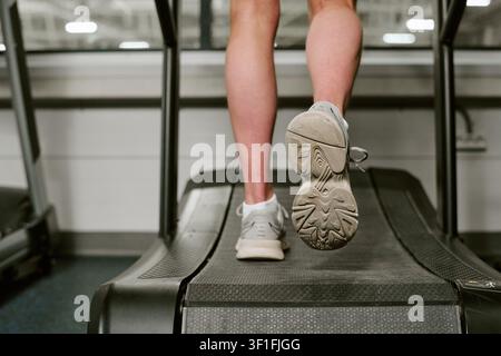 Man Running on Treadmill for Fitness Training in Gym Stock Photo