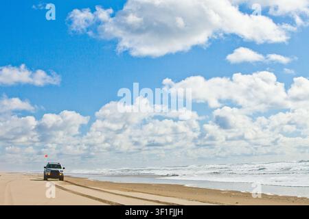Four wheel drive vehicle exploring a sandy beach Stock Photo