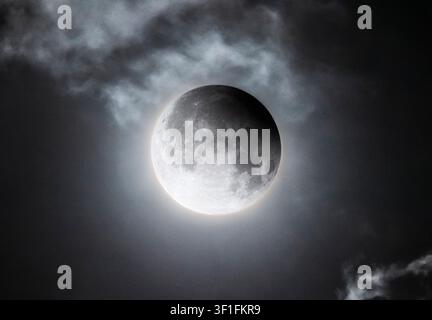 Full Moon During a Partial Lunar Eclipse Behind Clouds Stock Photo