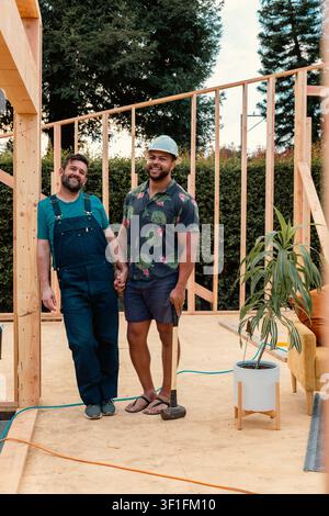 Gay couple holding hands at their new home build Stock Photo