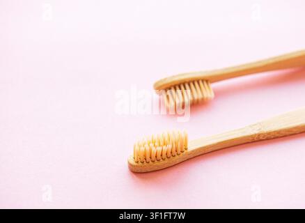 Bamboo toothbrushes on light pink background. Zero waste and use biodegradable and recyclable material concept. Flat lay. Stock Photo
