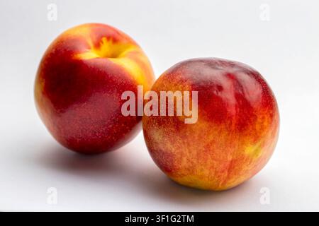 Two ripe nectarines fruit isolated on white background Stock Photo