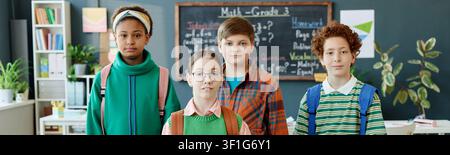 Portrait of Diverse Teenagers Standing in Classroom for Education Stock Photo