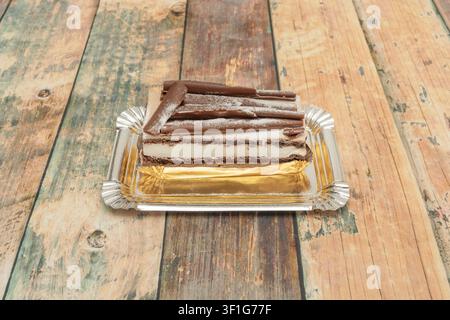 "Layered Black Forest Cake Topped with Chocolate Curls and Powdered Sugar on Gold Tray" Stock Photo