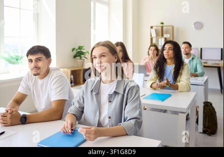 Attentive students listening in classroom during lecture, higher education concept Stock Photo