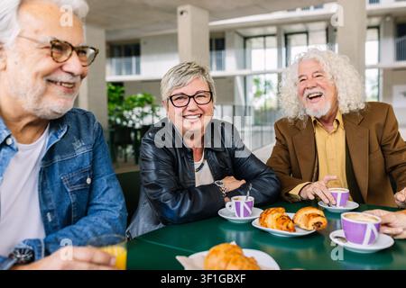 Group of elderly friends enjoying breakfast together Stock Photo