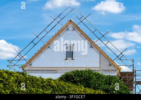 New House Under Construction with Facade Against Blue Sky Stock Photo