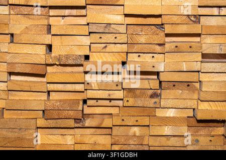 Stacked wooden boards and planks end grain texture background Stock Photo