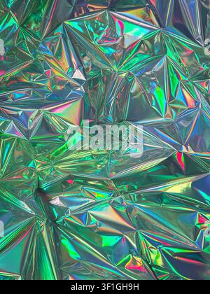 Crinkled holographic foil surface catching light with rainbow iridescent effects. Reflective, textured background ideal for futuristic and vibrant des Stock Photo