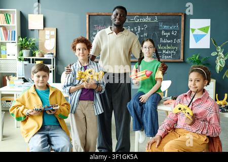 Portrait of Black Male Teacher Guiding Diverse Children in Stem Class Stock Photo