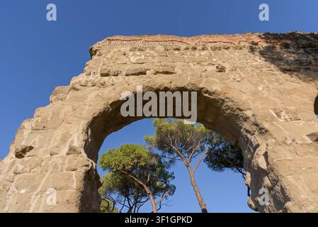 Detailed architectural shot of a historic Roman Empire viaduct showcasing the rough stone texture of a monumental archway in Parco degli Acquedotti Stock Photo