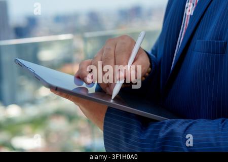 Business professional engages in partnership negotiations while using tablet to finalize agreement. This moment captures essence of successful deal in Stock Photo