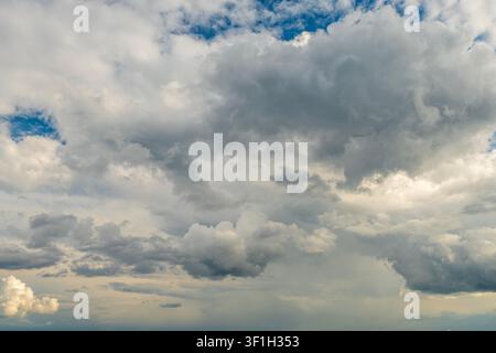 Dramatic storm clouds spreading across blue sky before rain Stock Photo