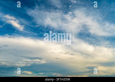 Dramatic sunset sky with dark cumulus and golden orange clouds Stock Photo