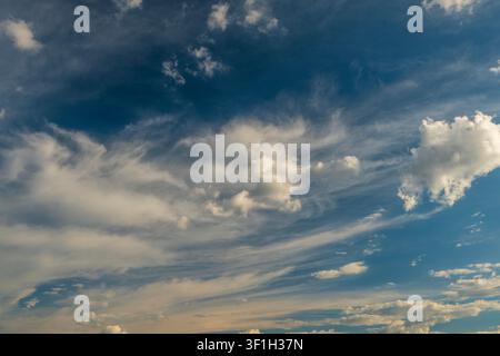 Beautiful blue sky with multi layered white cumulus and cirrus clouds Stock Photo