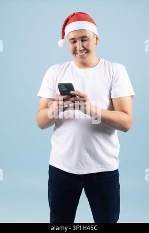 Young male using mobile phone for messaging during holiday season Stock Photo