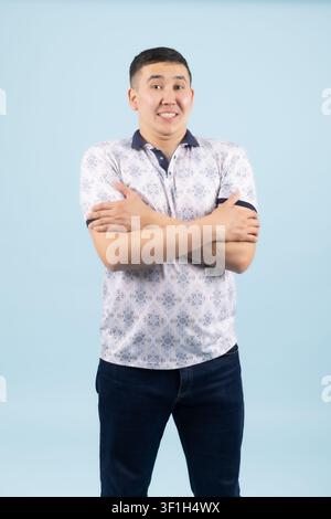 Young male standing confidently with crossed arms looking forward Stock Photo