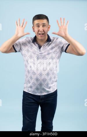 Young male holding hands up showing surprise and shock expression Stock Photo