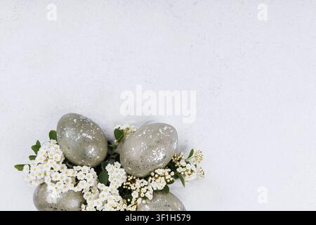 Easter eggs with white blossom flowers spring flat lay Stock Photo