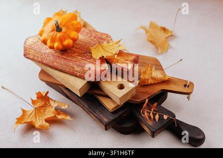 Fall decor with stacked boards and orange pumpkin Stock Photo