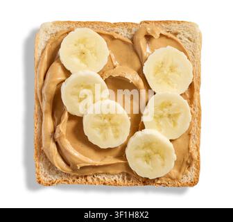 A top-down studio photograph of  slice of toast, topped with creamy peanut butter and fresh banana slices. Isolated on a clean white background, showc Stock Photo