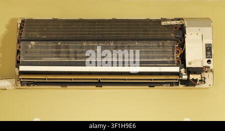 Indoor cooling unit showing extensive dust and grime build up on the evaporator coils and fan blades, indicating a need for professional hvac service Stock Photo