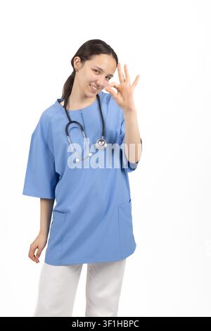 Young female medical nurse showing victory peace sign gesture Stock Photo