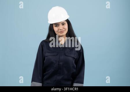 Young professional female engineer wearing white safety hard hat Stock Photo