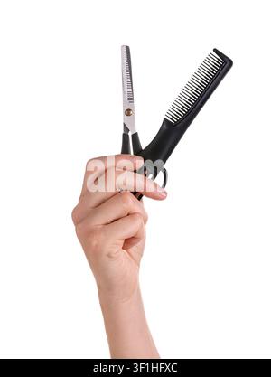 Hairdresser holding thinning scissors and comb on white background, closeup Stock Photo
