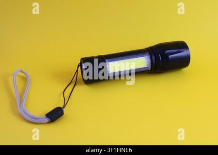 Small rechargeable pocket LED flashlight Stock Photo