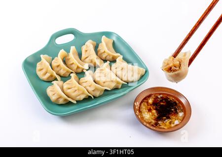 Winter Melon and Pork Dumplings on White Background with Dipping Sauce Stock Photo