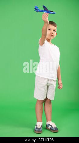 Child boy holds toy foam airplane in hands Stock Photo