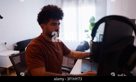 Professional man working from home, focused on his laptop Stock Photo