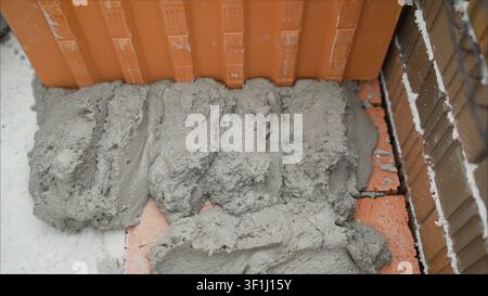 Ceramic block - construction application. Wall blocks made from red porous ceramics with rectangular holes on a pallet Stock Photo